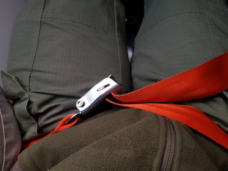 Seat belt fastened on an airplane passengerの写真素材