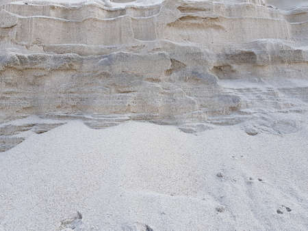 Stone rock covered with gray sandの写真素材