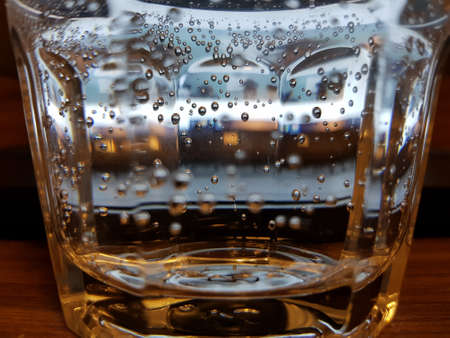 Air bubbles in a glass of waterの写真素材