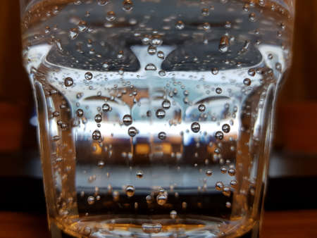 Air bubbles in a glass of mineral waterの写真素材