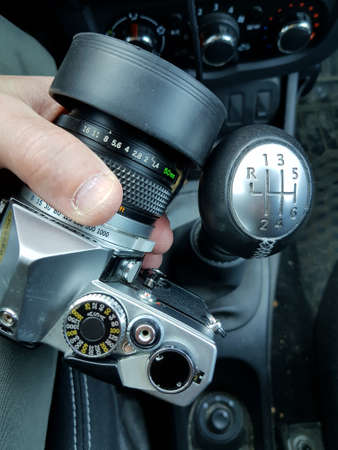 A man holding a film camera in his handの写真素材