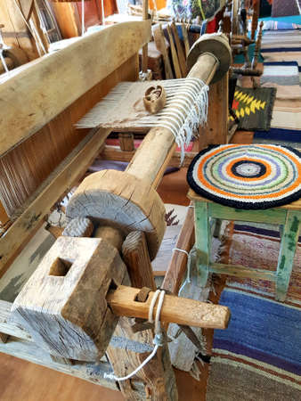 Carpets are woven on an antique wooden loomの写真素材