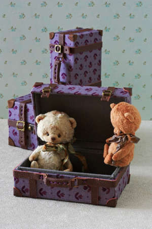 Teddy bears sitting in a toy suitcaseの写真素材