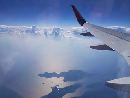 The plane flies in the blue skyの写真素材