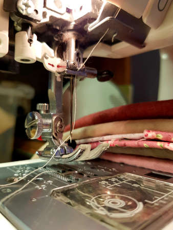 The sewing machine sews fabrics