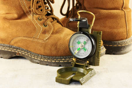 Compass and old trekking hiking boots