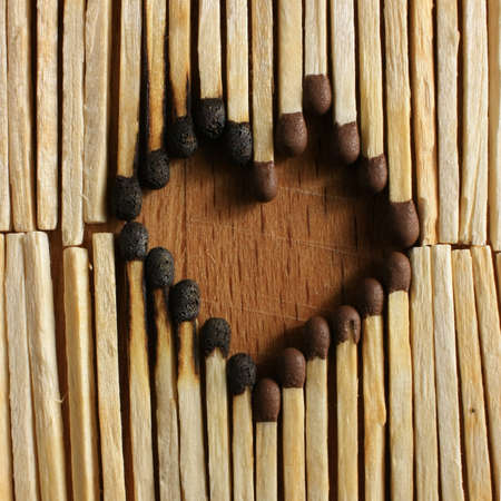 The figure of the heart, lined with burnt matchesの写真素材