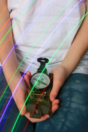 Child holding a compass in his handsの写真素材