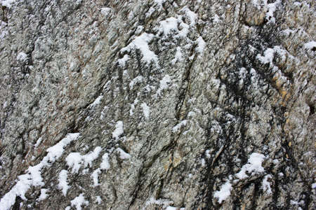 Gray stone rock in the snowの写真素材
