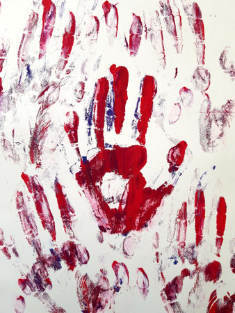 Hand prints on white paper. Abstract background. Close-up.の写真素材