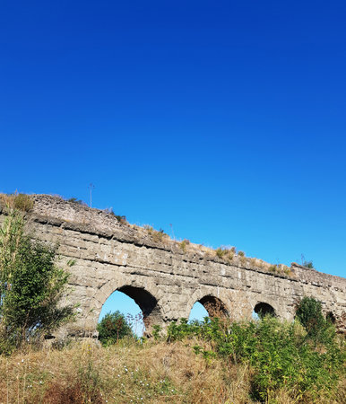 Old stone bridge over the river with blue sky in the background.の写真素材
