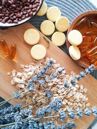 Herbal medicine and dried lavender on wooden table, top view