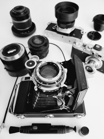 Old camera and lenses on a white background. Black and white photo.の写真素材