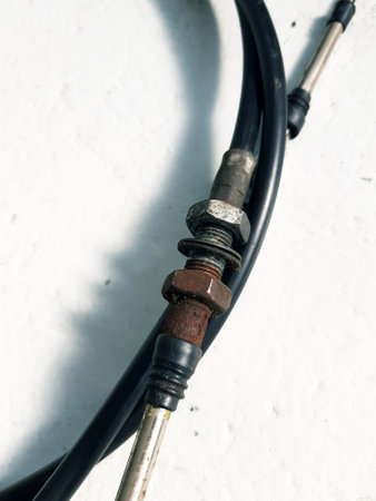 Close up of an old electric cable on a white wall background.の写真素材