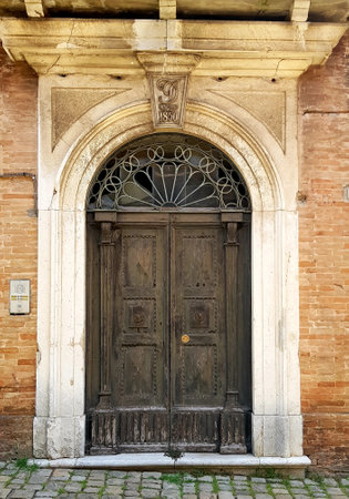 Old wooden door in the historic center of Bologna, Italyの写真素材