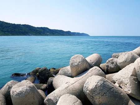 rocky coast of the sea, blue sky and white clouds in the backgroundの写真素材