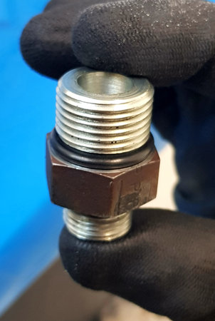 close up of a plumber's hand with a wrench fixing a pipe