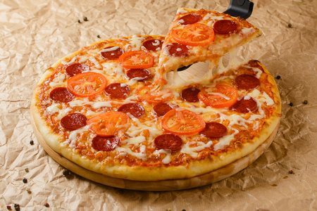 Hot pizza on craft paper backgroundの写真素材
