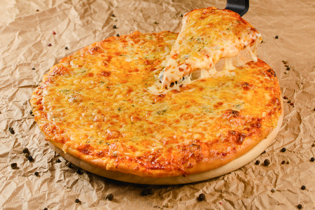 Hot pizza on craft paper backgroundの写真素材