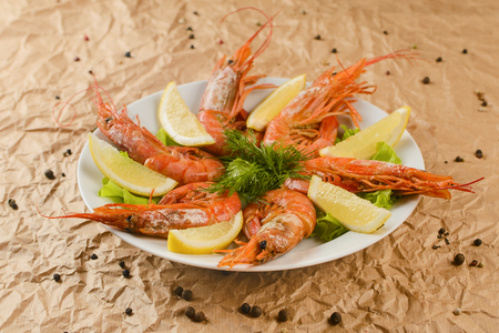 fried shrimps with lemon on plateの写真素材
