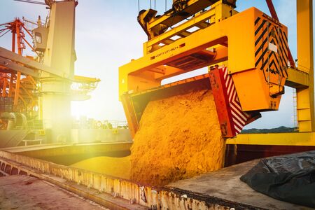 Raw sugar bulk loaded into large vessel hole by rotainer for export. Sugar bulk products transport...