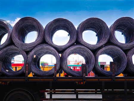 Coils of steel wire rod on truck trailer at industrial zone. Truck receive steel wire rod from warehouse container unstuffing area.の写真素材