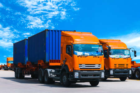 Truck carrying two twenty-foot containers at a port terminal. Container handling, transportation, and shipping.の写真素材