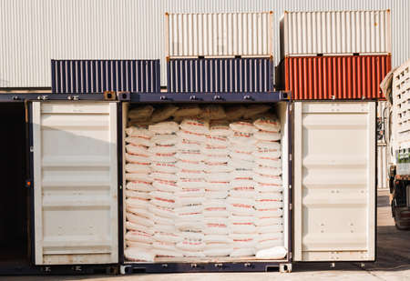 Rice bags stuffed in containers at a warehouse for export.