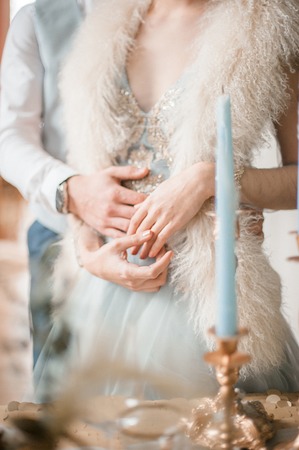 one young slim bride dressing in lace wedding dress preparing for ceremonyの写真素材