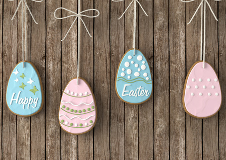 Easter homemade cookies in shape of eggs in front of wooden wall.