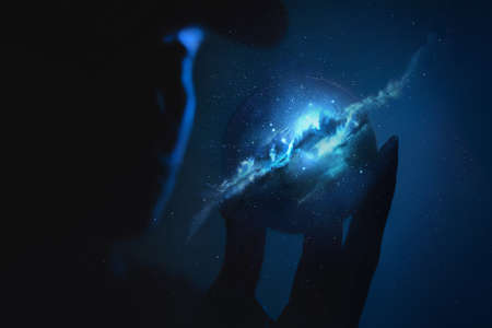 in bright blue, a man holds a small planet in his hands