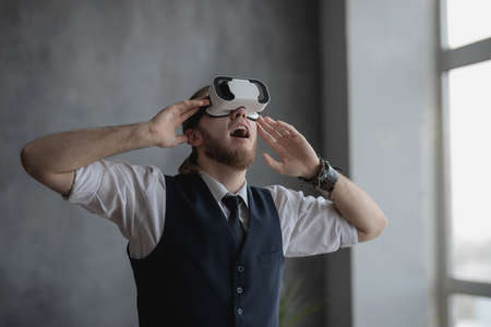 a guy with virtual reality glasses is playing