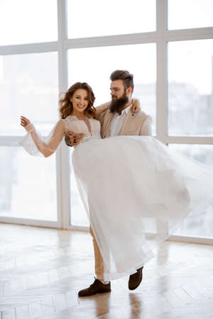 guy circling a girl in a white dressの写真素材