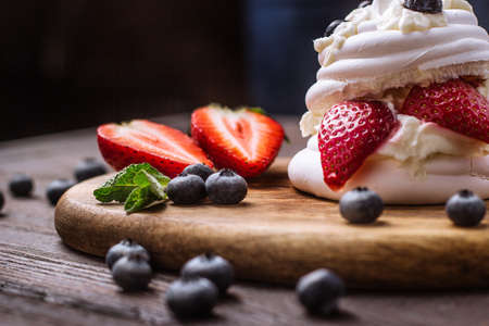 dessert with strawberries and blueberries on a wooden trayの写真素材