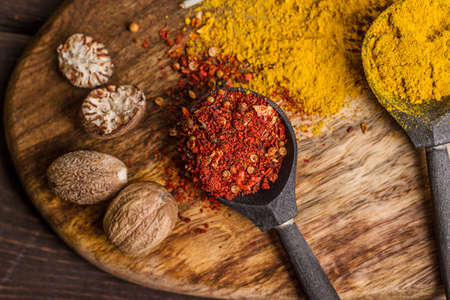 black wooden spoons with colorful balls of spices
