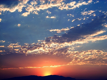 Colorful sunset behind the mountainsの写真素材