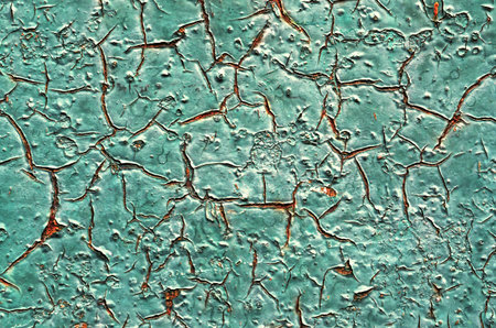 Grunge background with peeling paint on a metal surface.