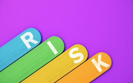 Risk word on colorful wooden tags over purple background with copy spaceの写真素材