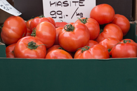 Red Tomatoes in a green Cardboard box , Vegetables in the marketの写真素材