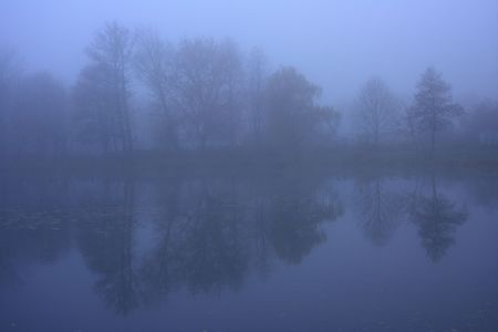 Road on a dam by the lake in the mistの写真素材