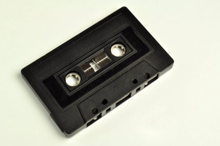 black audio cassette on a light background