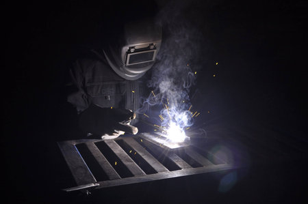 welder connects the part with manual arc weldingの写真素材