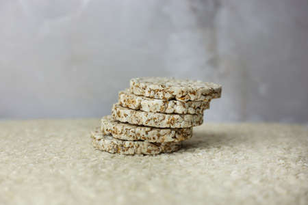 Rice buckwheat cake on a background of strewn rice groatsの写真素材