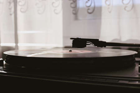 Playing classic vinyl records in daylight close-upの写真素材