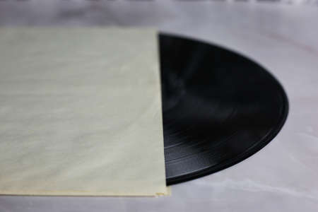 Classic vinyl record with packaging closeup on a light background, obsolete data storage, musicの写真素材
