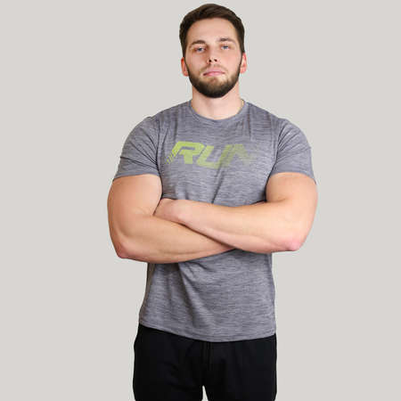Young man of athletic build stands with his arms folded and looks forward on an isolated backgroundの写真素材
