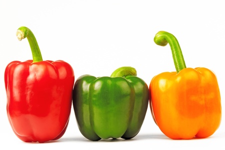 Three multi-colored paprikas on the white isolated backgroundの写真素材