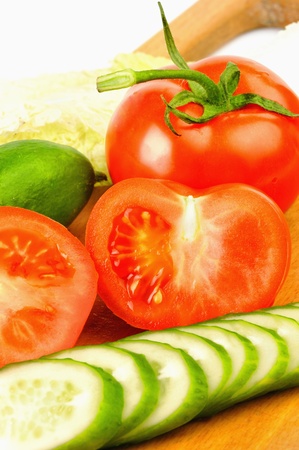 Tomatoes and cucumbers beautifully cut on the Boardの写真素材
