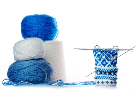 Balls of yarn and mittens knitted wool are