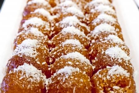 Honey cake topped with coconutの写真素材